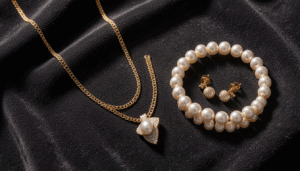 High-karat Bahraini gold jewelry set with pearls displayed as investment pieces on dark velvet