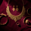A complete gold bridal jewelry set including necklace, earrings and bangles arranged on velvet for a Bahrain wedding