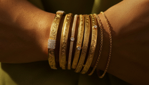 Stacked gold bangles and bracelets styled the Bahraini way on a woman's wrist with traditional and modern pieces