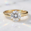 Elegant diamond solitaire ring in Bahrain set in gold displayed on white marble with soft jewelry lighting