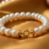 Elegant pearl bracelet for women on a gold fabric background, classic Bahraini style