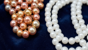 Natural and cultured pearls displayed side by side on dark velvet at a Bahrain jewelry store