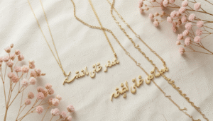 Gold personalized name necklace with Arabic calligraphy script on a neutral background in Bahrain