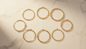 Collection of gold bracelets for women in Bahrain displayed on white marble
