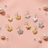 Safe and stylish kids' earrings in Bahrain displayed on a soft pink background