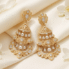 Elegant Bahraini bridal earrings in gold and diamonds displayed on a soft white fabric ready for a wedding