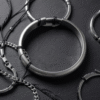 Collection of mens bracelets in Bahrain featuring gold chain silver bangle and leather designs on dark surface