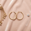 Collection of chandelier hoop and stud earrings displayed to show options for different face shapes